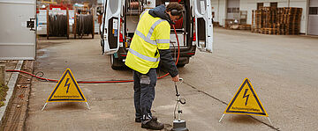 Absperrung und Warnschilder am Kabelmesswagen